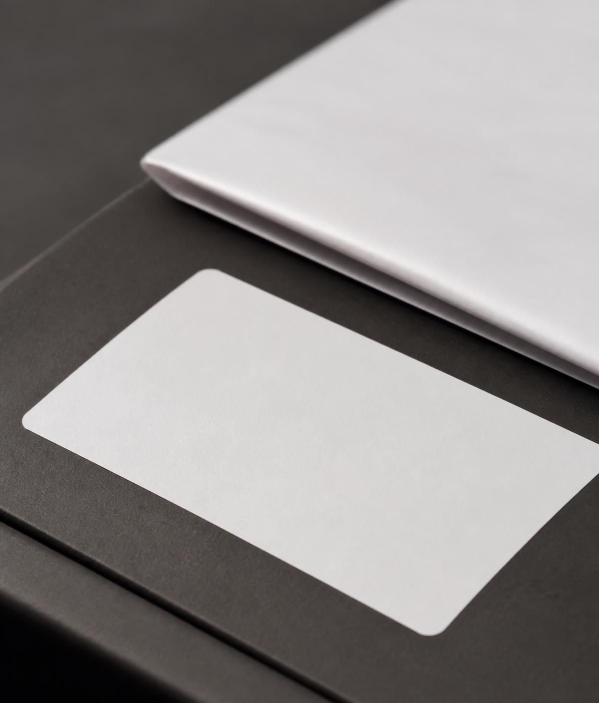 Blank shipping label and folded documentation resting on a dark surface
